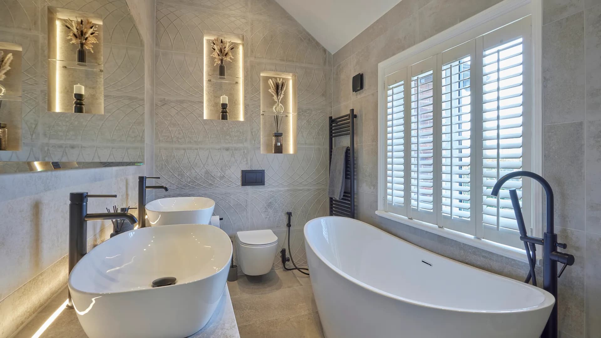 His and hers bathroom with freestanding bath and twin vanity