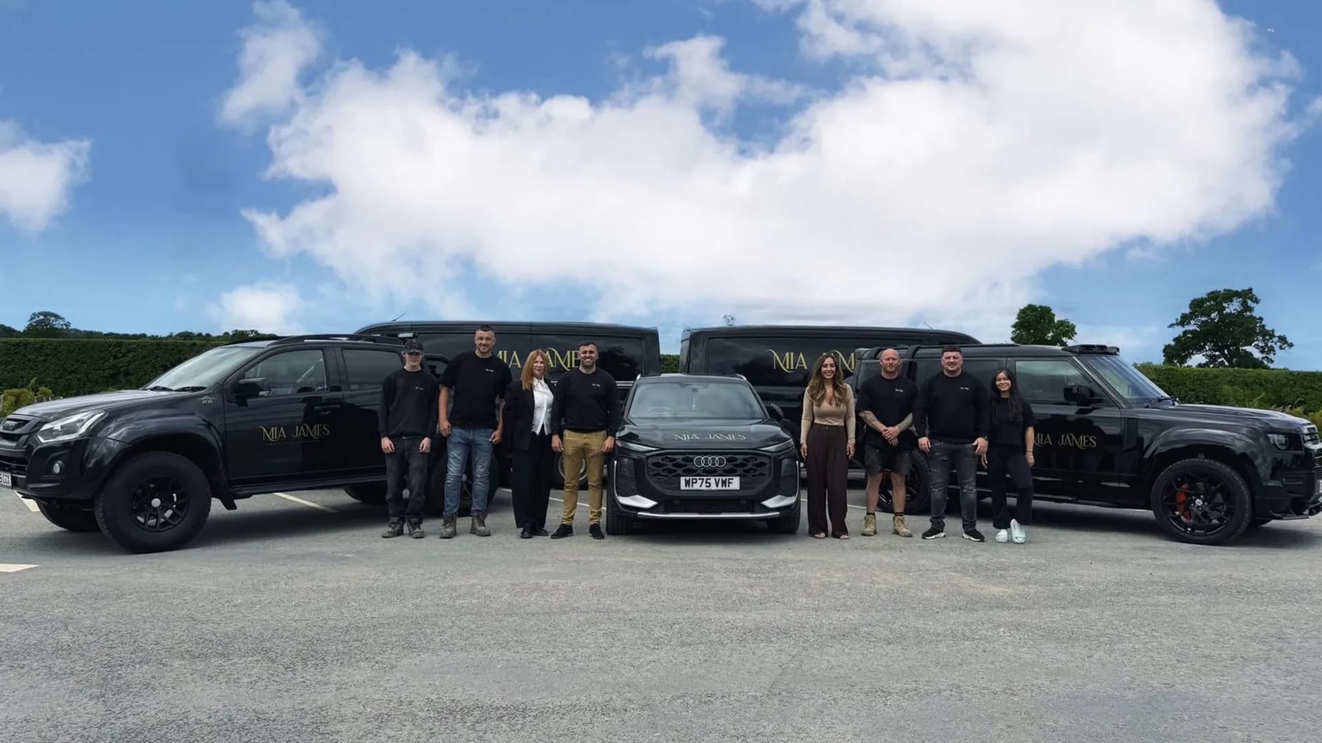 The Mia James Construction & Interiors team with the company fleet