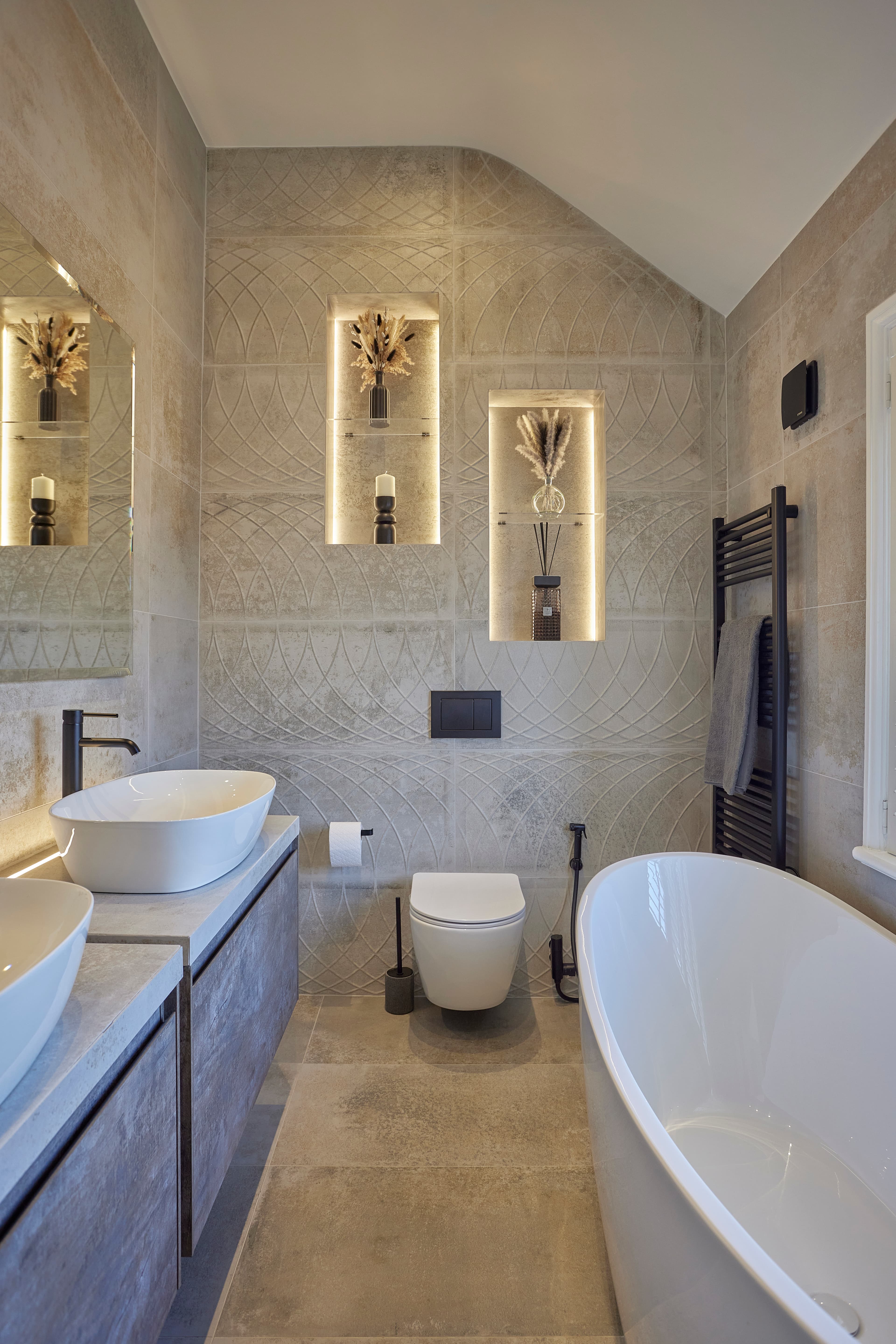 His and hers bathroom with freestanding bath by Mia James