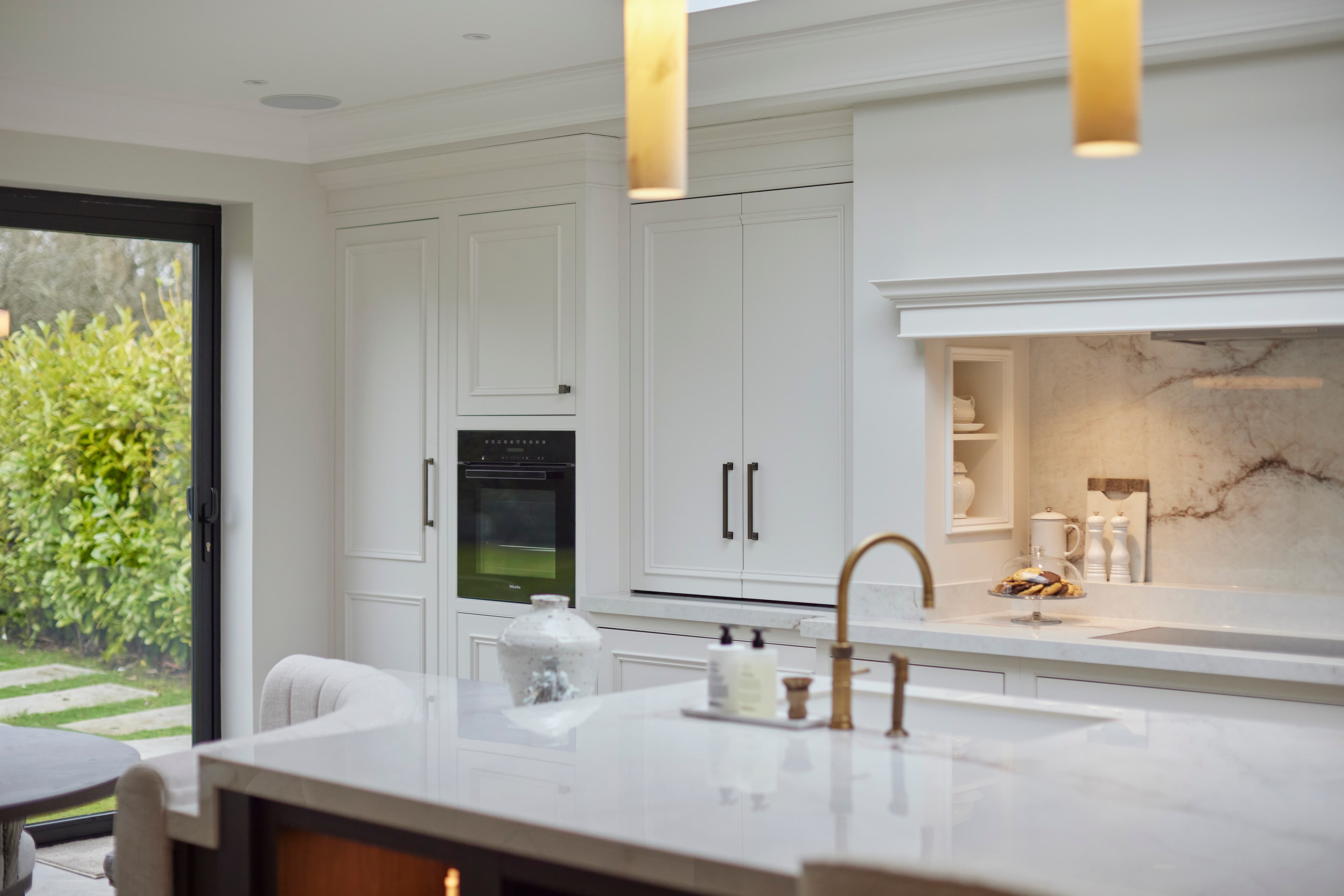 Bright Noble House kitchen with marble worktops and island seating